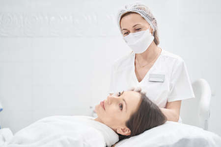 Woman receiving skincare treatment in beauty salonの写真素材