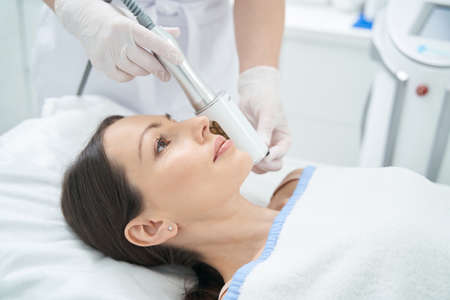 Female experiencing anti-wrinkle endosphere treatment on her face