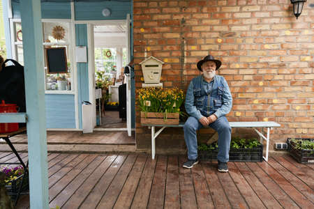 Senior man selling seedling near flower shopの写真素材