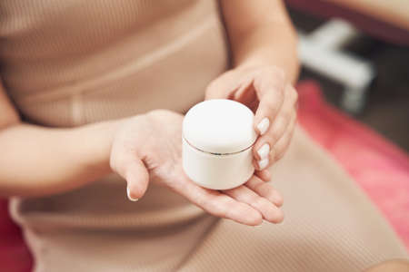 Beautiful female arms demonstrating organic cosmetic productの写真素材