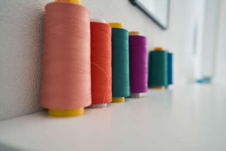 Colourful spools are standing in tailor office