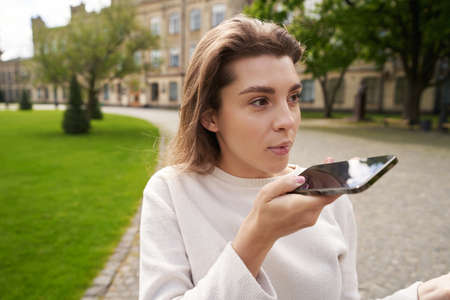 Young woman talking on mobile phone on the street