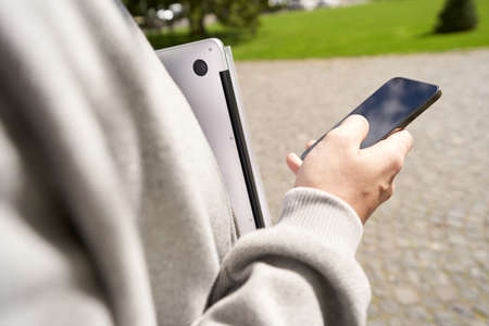 Man using modern mobile phone on the street