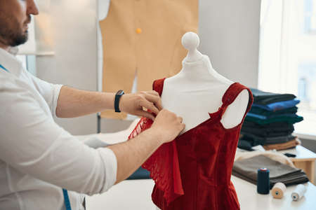 Fasion designer sewing eleant female dress in own atelierの写真素材