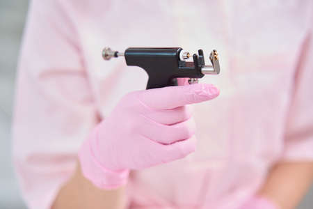 Professional device for piercing in hands of a medical workerの写真素材