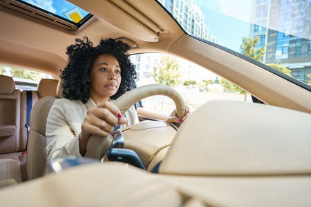 Pretty mixed race woman driving a carの写真素材