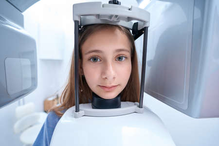 Tranquil female patient undergoing dental radiography procedureの写真素材