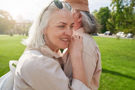 Happy mature woman caressing her grey-haired partnerの写真素材