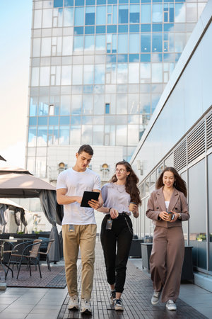 Man demonstrates information on tablet to colleague during coffee breakの写真素材