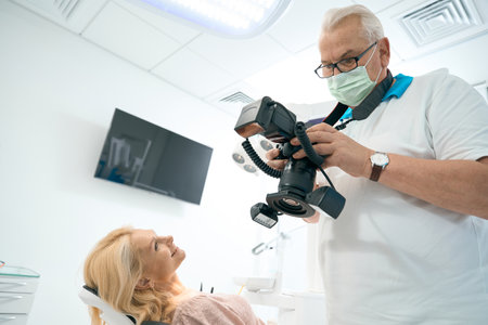 Doctor looking at photo of teeth after whitening