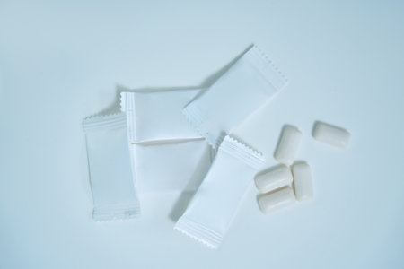 Printed chewing gum pads with white packaging lie on tableの写真素材
