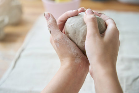 Large lump of clay in female handsの写真素材