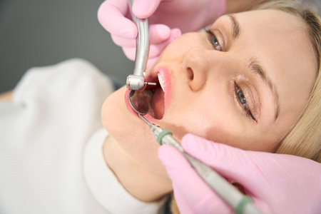 Young lady sitting in a chair being treated for teethの写真素材