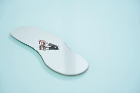Close-up photo of dental pin for teeth, lying on mirror
