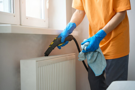 Close up photo of lady cleaning heaters