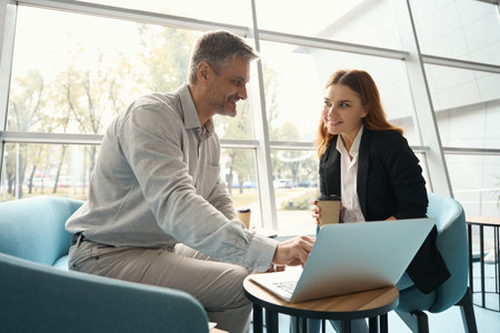 Office employees look through the work material in the laptop