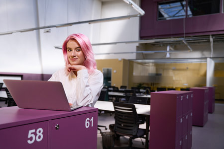 Woman sitting in coworking space and working online