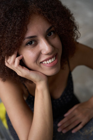 Adorable young woman smiling and looking contentedの写真素材