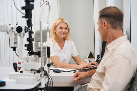 Smiling doctor receiving patient in office in hospital
