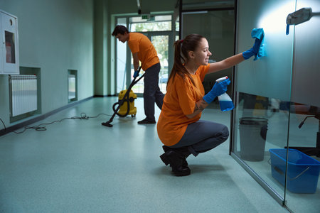 Professional cleaners working as team while tidying up the apartmentの写真素材