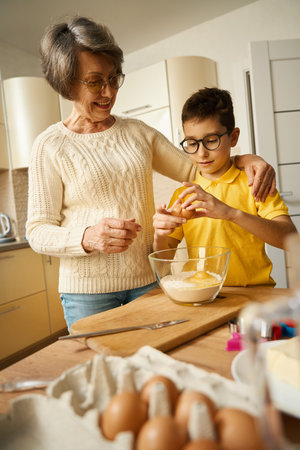 Kid came to visit granny and preparing doughの写真素材