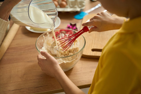 Grandmother cooking with grandson tasty food at homeの写真素材