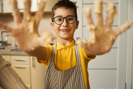 Close up photo of kid cooking at home