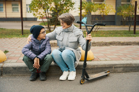 Boy and grandmother having fun, spending time outsideの写真素材