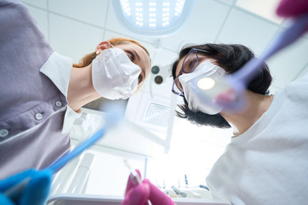 Two medical workers in the process of dental manipulationの写真素材