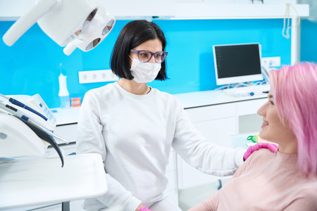 Smiling woman with pink hair at a dentist appointmentの写真素材