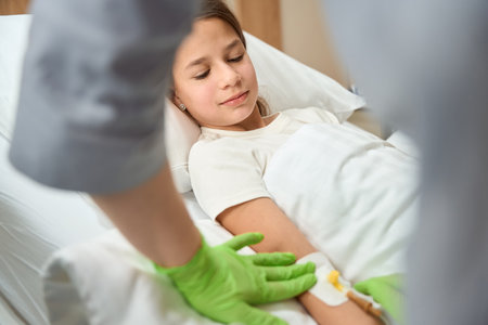 Nurse performs a medical manipulation on a small patientの写真素材