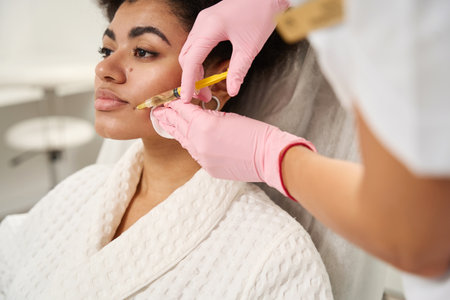 Medical worker doing facial plasmolifting for young femaleの写真素材