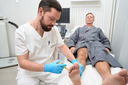 Focused healthcare specialist performing biopsy sampling from ankle of patientの写真素材