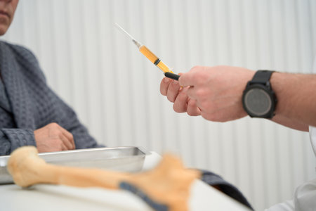 Syringe for biopsy sampling in hand of hospital workerの写真素材
