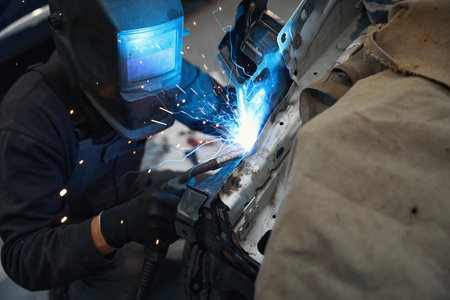 Professional man working in the welding shop