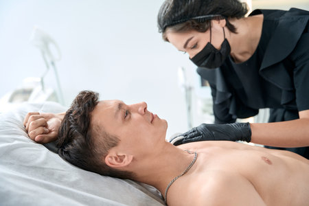 Young male in salon on injections therapy