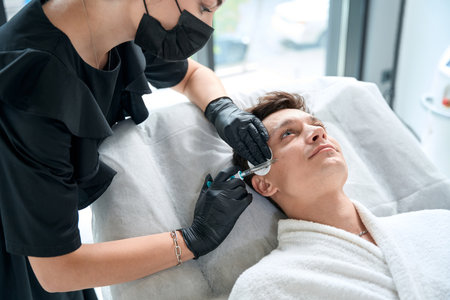 Male making in clinic face beauty injections procedureの写真素材