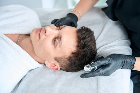 Nurse apply serum for face of redness on skinの写真素材