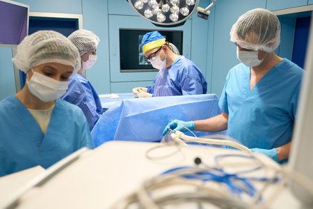 Anesthesiologist delivers medicine to the patient through a mask