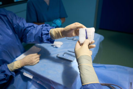 Assistant in the operating room passes the scalpel to surgeonの写真素材