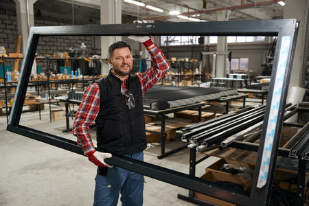 Man carries finished product around the workshopの写真素材