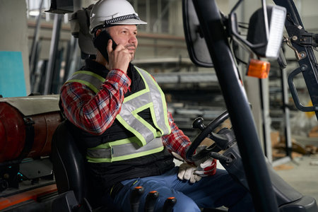 Employee sitting in loading truck and working at enterprise