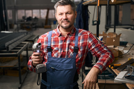 Portrait of employee ready to work in factoryの写真素材