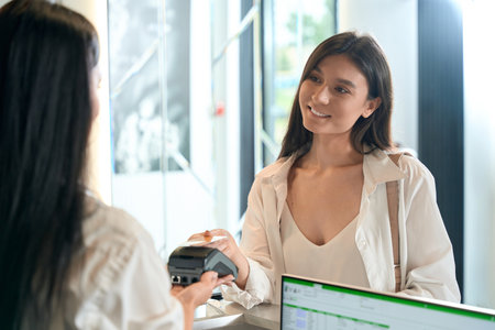 Smiling female finishing shopping in beauty salonの写真素材