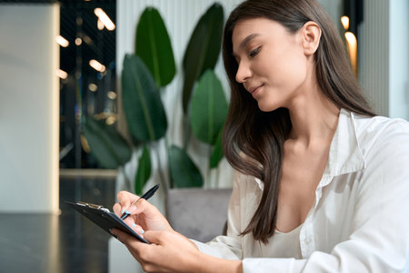 Lady studying spa services catalog before treatment