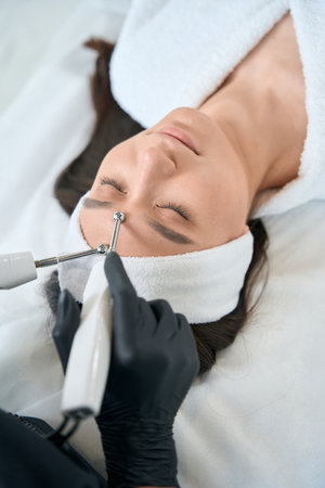 Nurse doing skin rejuvenation, working in salon