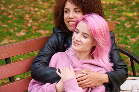 Happy lesbian woman spending time with her affectionate girlfriend outdoorsの写真素材