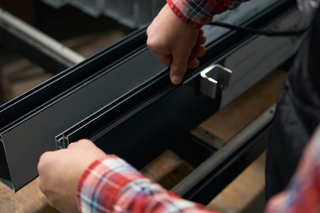 Male working with metal profile in the factoryの写真素材