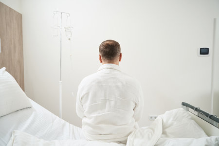 Adult Caucasian male is resting in the sickroomの写真素材