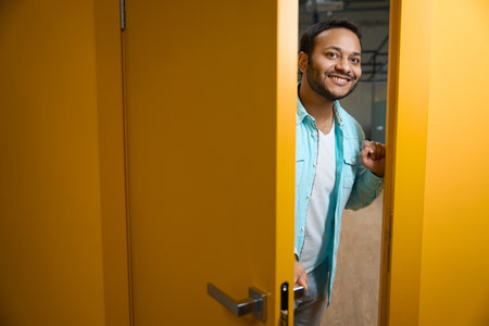Portrait of Hindu man inviting you to enter officeの写真素材